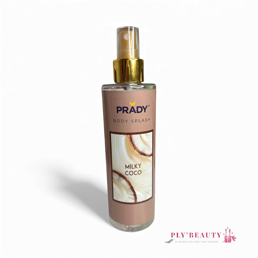 Spray corporel Prady Milky Coco 250 ml, brume parfumée gourmande au lait de coco, flacon transparent avec étiquette beige et détails dorés, photo de noix de coco en fond.