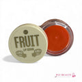 Gommage lèvres Fruit Bell – pot ouvert avec texture exfoliante orange vif.